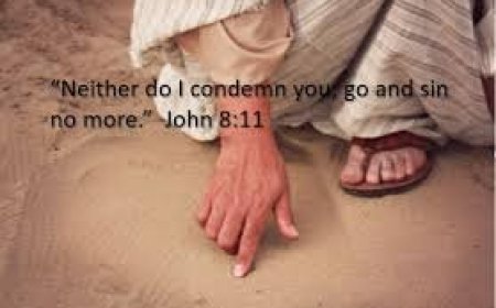 What was Jesus writing in the sand when he bent down?