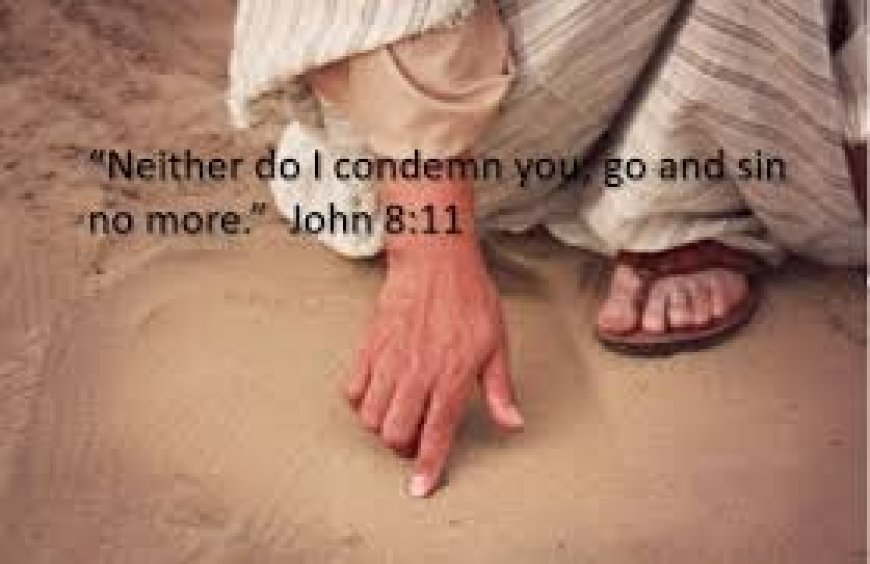 What was Jesus writing in the sand when he bent down?